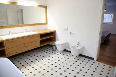a bathroom with a sink and a toilet and a mirror at Maribor Luxury Country House Volicina 5* in Spodnja Voličina