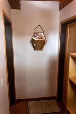 a hallway with a shelf on the wall at Apartma Tisa in Zreče
