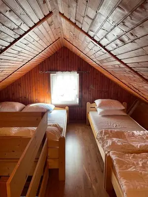 a room with two bunk beds in a cabin at Apartma Tisa in Zreče