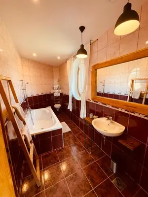 a large bathroom with a tub and a sink at Villa Goričko in Šalovci