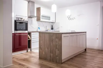 a kitchen with white appliances and a wooden counter top at Apartma Tia 2 in Zreče