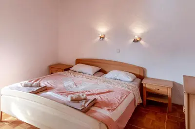 a bedroom with a bed with two pillows on it at Gostišče Marin Miler in Prevalje