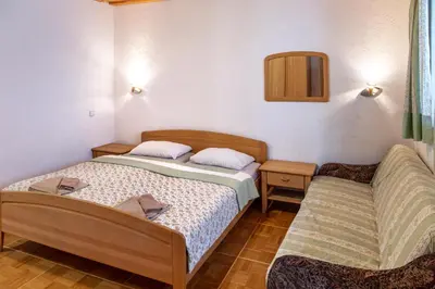 a small room with two beds and a mirror at Gostišče Marin Miler in Prevalje