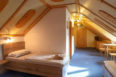 a bedroom in a tiny house with a bed at Gostišče Marin Miler in Prevalje