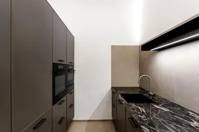 a kitchen with a counter top and a sink at Ljubljana Palace Suites in Ljubljana