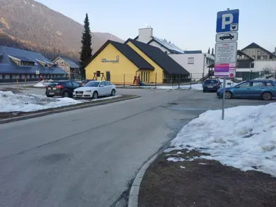 a street with cars parked on the side of the road at Cosy Forest in Kranjska Gora