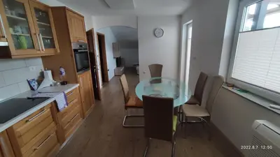 a kitchen with a glass table and some chairs at Prijetno stanovanje v bližini Term 3000 - Vivat in Moravske Toplice