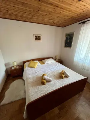 a bedroom with a bed with two shoes on it at Apartma Zdar in Kobarid