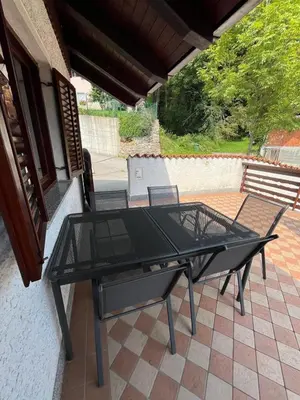 a black table and chairs on a patio at Apartma Zdar in Kobarid