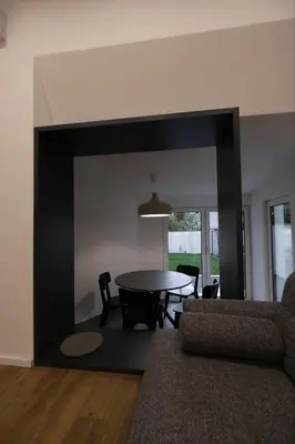 a living room with a table and a large mirror at Apartments Emona FREE Parking & gym in Ljubljana