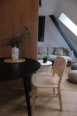 a dining room with a table and two chairs at Apartments Emona FREE Parking & gym in Ljubljana