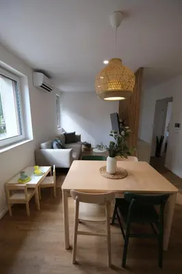 a living room with a table and a couch at Apartments Emona FREE Parking & gym in Ljubljana