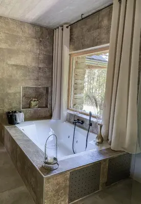 a large bath tub in a bathroom with a window at Koča na samem Prestiž in Šalovci
