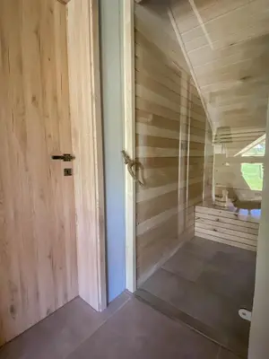 a room with a wooden wall and a door at Koča na samem Prestiž in Šalovci