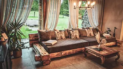 a living room with a couch and a table at Koča na samem Prestiž in Šalovci