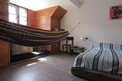 a bedroom with a hammock in the middle of a room at Entire apartment in the center with free parking in Ljubljana