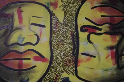 a painting of two faces on a wall at Entire apartment in the center with free parking in Ljubljana
