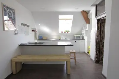 a kitchen with a table and a bench in a room at Entire apartment in the center with free parking in Ljubljana