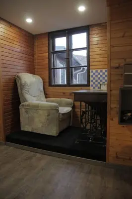 a room with a chair and a desk and a window at Entire apartment in the center with free parking in Ljubljana