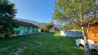 a yard with a house and a tub at Apartma Patricija - Cozy apartments for 2 or 4 people in Tolmin
