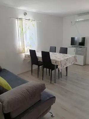 a living room with a table and chairs and a couch at Apartma Patricija - Cozy apartments for 2 or 4 people in Tolmin