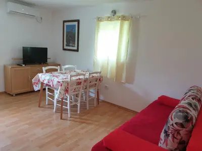 a living room with a table and a couch at Apartma Patricija - Cozy apartments for 2 or 4 people in Tolmin