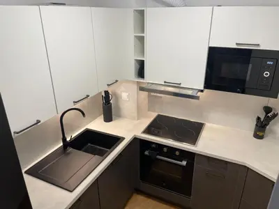 a kitchen with a sink and a stove and a microwave at Apartma Pohorske terase Brumen Mariborsko Pohorje in Pohorje