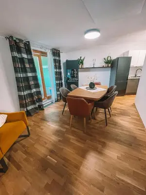 a kitchen and dining room with a table and chairs at Apartma Pohorske terase Brumen Mariborsko Pohorje in Pohorje