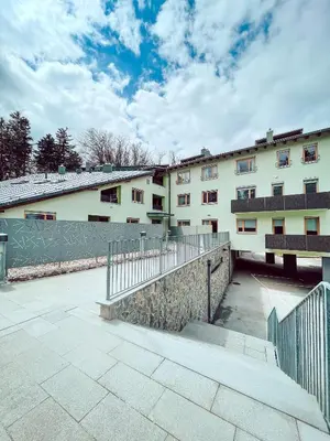 a building with a fence in front of it at Apartma Pohorske terase Brumen Mariborsko Pohorje in Pohorje
