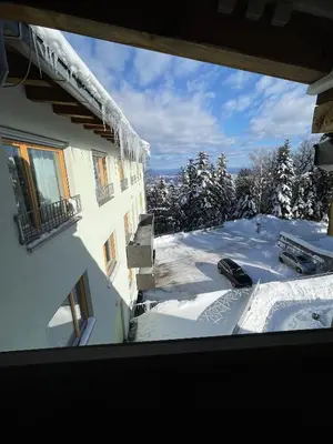 a view from a window of a building with snow at Apartma Pohorske terase Brumen Mariborsko Pohorje in Pohorje