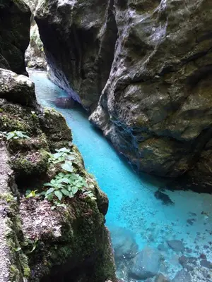 a pool of blue water between two rocks at Apartma Melita in Kobarid