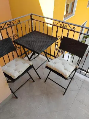 two chairs and a table on a balcony at Apartma Melita in Kobarid