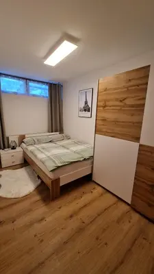 a bedroom with a bed and a wooden floor at Alpski škrat, Kranjska Gora in Kranjska Gora
