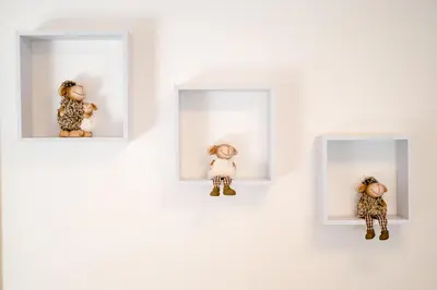 a group of small stuffed animals in white boxes at Alpski škrat, Kranjska Gora in Kranjska Gora