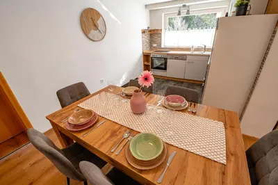a dining room with a wooden table and chairs at Alpski škrat, Kranjska Gora in Kranjska Gora