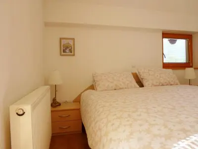 a small bedroom with a bed and a window at Apartment Jalps 3 in beautiful Bohinjska Bistrica in Bohinj
