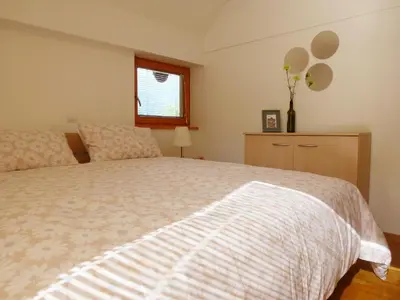 a bedroom with a bed and a window at Apartment Jalps 3 in beautiful Bohinjska Bistrica in Bohinj
