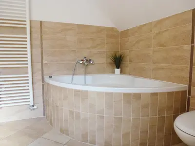 a bath tub in a bathroom with a toilet at Apartment Jalps 3 in beautiful Bohinjska Bistrica in Bohinj