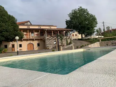 a swimming pool in front of a house at G House in Dutovlje