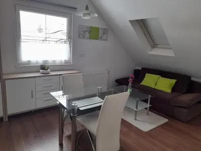 a living room with a table and a couch at Apartma Lena in Kranjska Gora