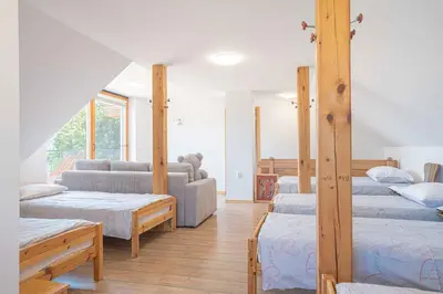 a living room with four beds and a couch at Holiday home in Loka pri Zusmu Stajerska Untersteiermark 26086 in Loka pri Žusmu