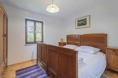 a bedroom with a wooden bed and a window at Holiday home in Loka pri Zusmu Stajerska Untersteiermark 26086 in Loka pri Žusmu