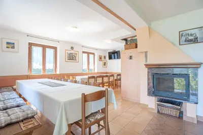 a dining room with a table and a fireplace at Holiday home in Loka pri Zusmu Stajerska Untersteiermark 26086 in Loka pri Žusmu