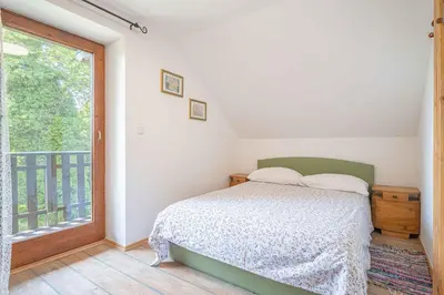 a bedroom with a bed and a large window at Holiday home in Loka pri Zusmu Stajerska Untersteiermark 26086 in Loka pri Žusmu