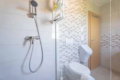 a bathroom with a shower with a toilet and a shower head at Holiday home in Loka pri Zusmu Stajerska Untersteiermark 26086 in Loka pri Žusmu