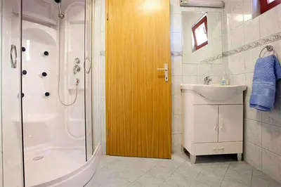 a bathroom with a shower and a toilet and a sink at Holiday home in Otocec Kranjska Krain 26062 in Otočec