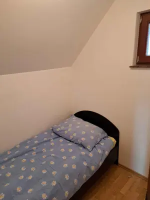 a bed with a blue comforter in a bedroom at Holiday home in Otocec Kranjska Krain 26062 in Otočec