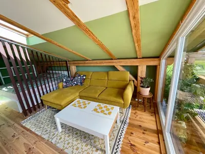 a living room with a couch and a table at Mini Loft close to Logar Valley in Rečica ob Savinji