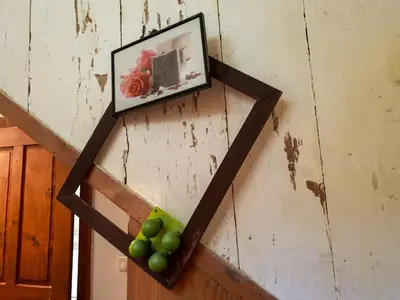 a bunch of green grapes on a wall with a picture at HIŠA VELIKANKA_Giantess in Kostel