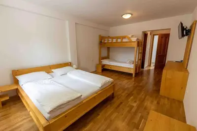 a bedroom with a bed and a wooden floor at Pr'Finzgar in Brezje